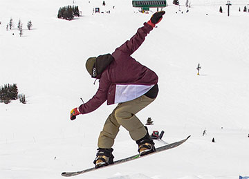 A snowboarder jumping
