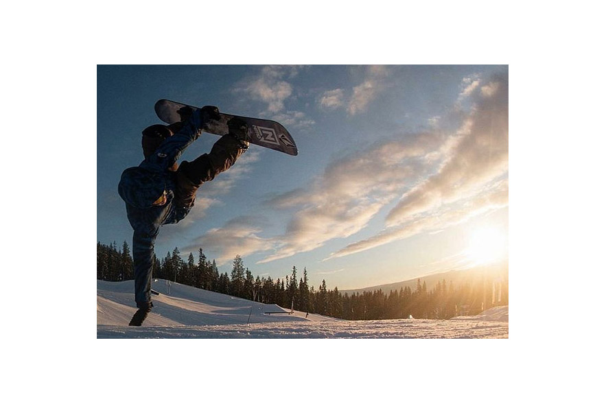 snowboard hand drag at sunset