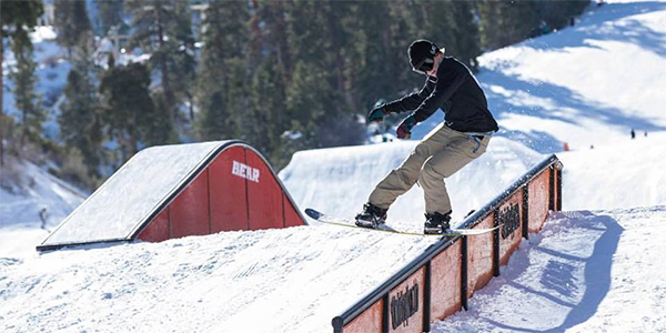 a snowboarder on a rail