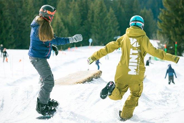 A snowboard instructor and student